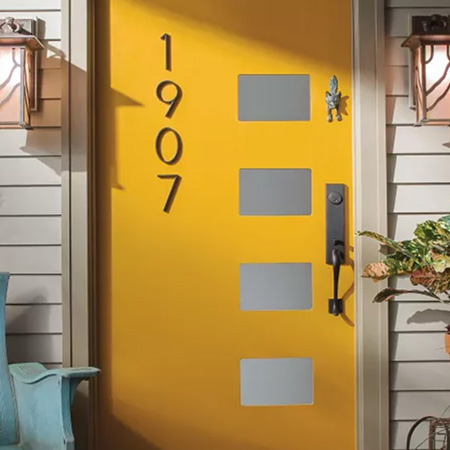 Inviting yellow door with enchanting light fixtures